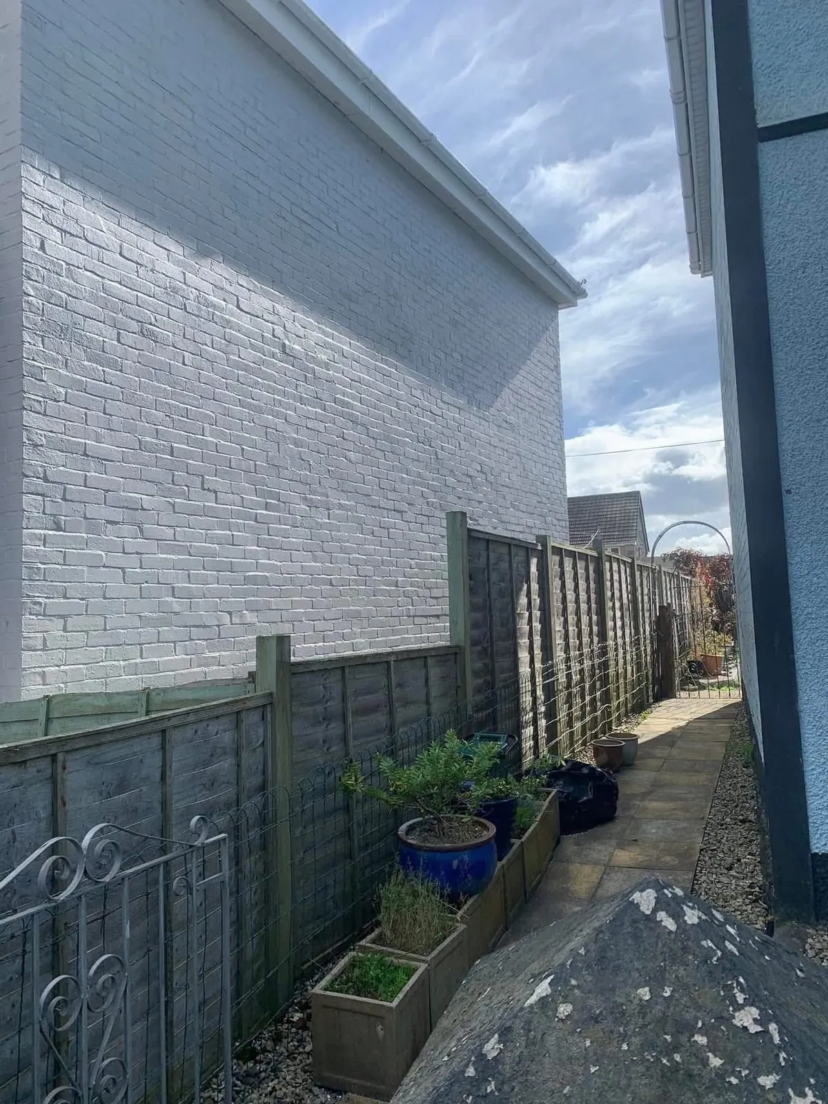 Freshly painted brick wall after preparation and masonry paint in Boscastle